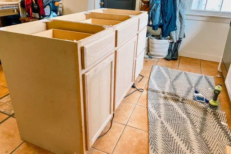 How is a kitchen island attached to the floor