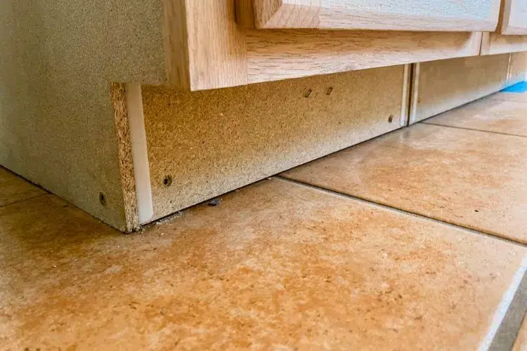 How do you secure a kitchen island to a tile floor
